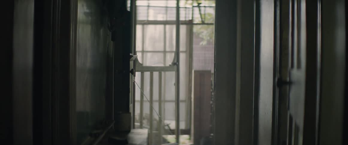A young boy runs through an old house and out the door, chasing a sense of freedom