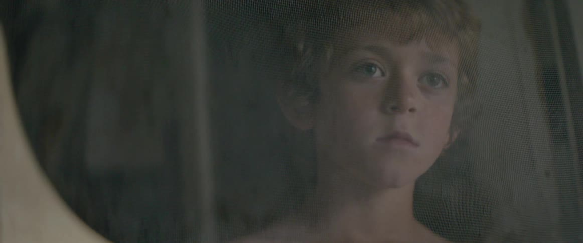 A child looks around curiously