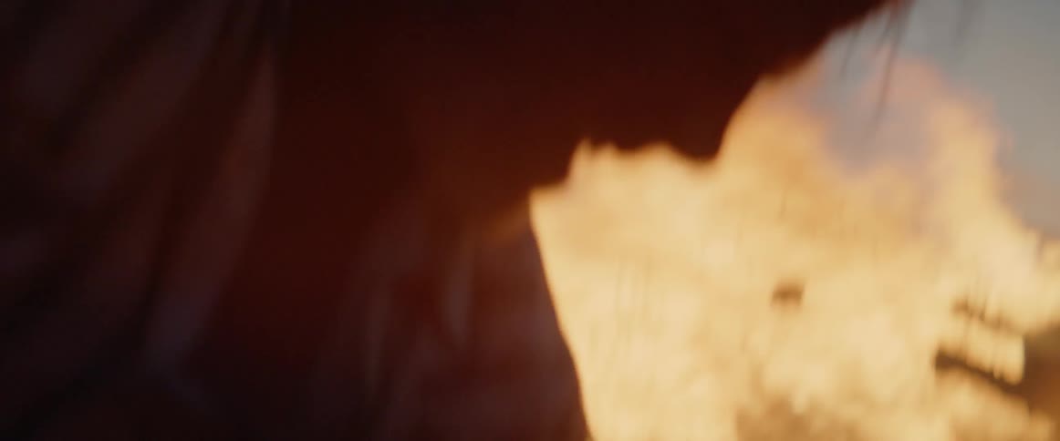A man throwing dirt on a fire with a shovel
