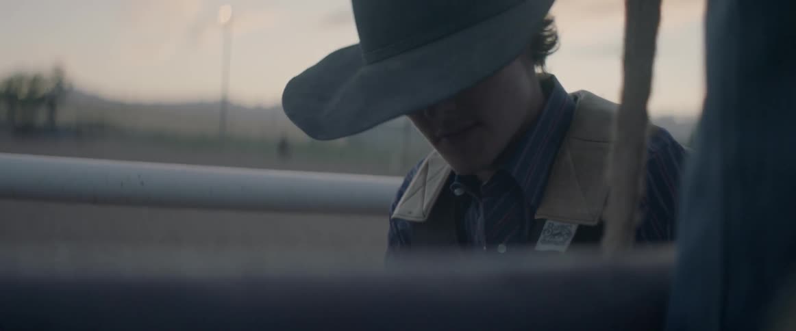 A bull rider prepares himself to mount the bull