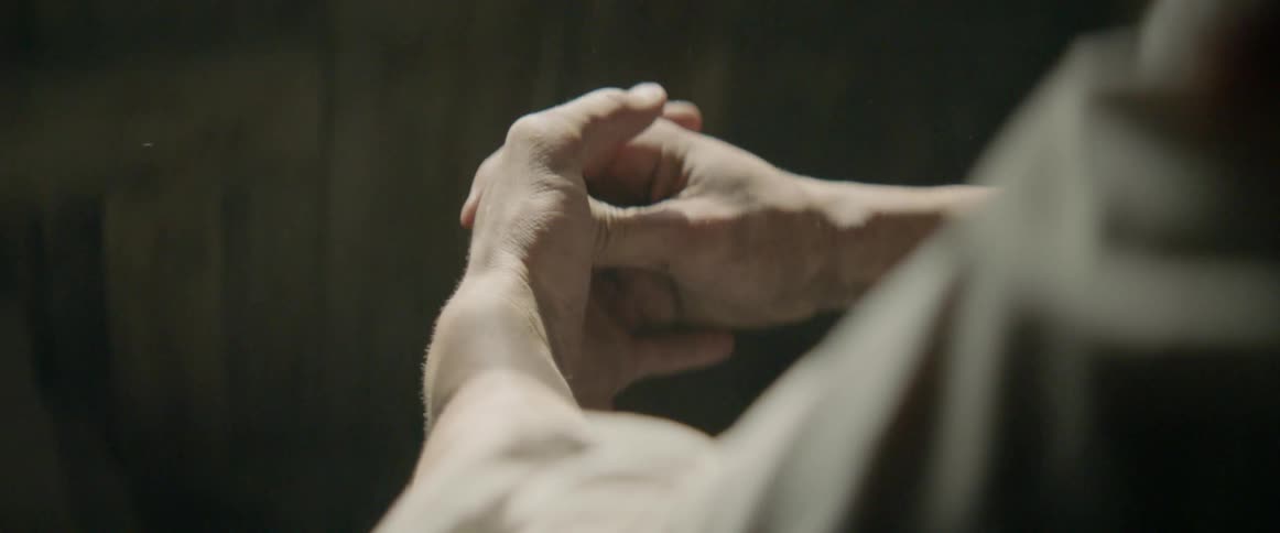 A man rubs his hands together