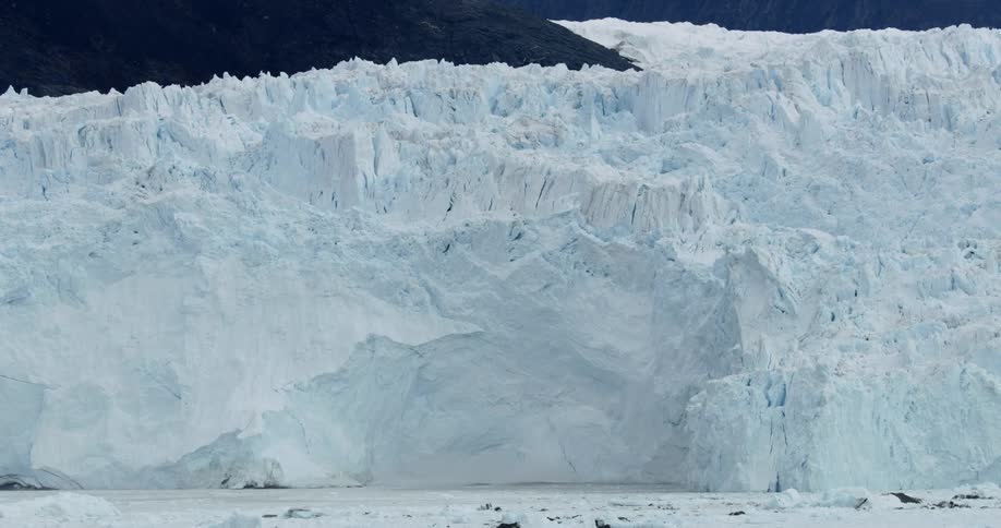 A large wall of ice is collapsing into the ocean
