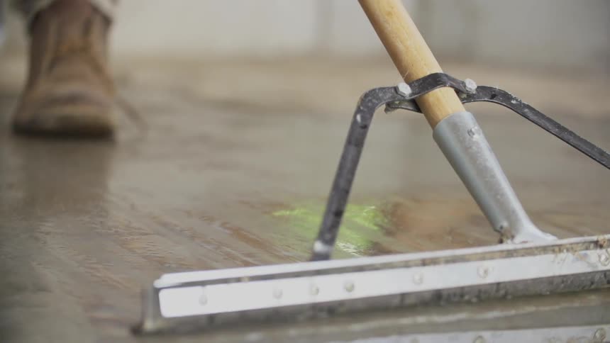 Man using a broom to push water out