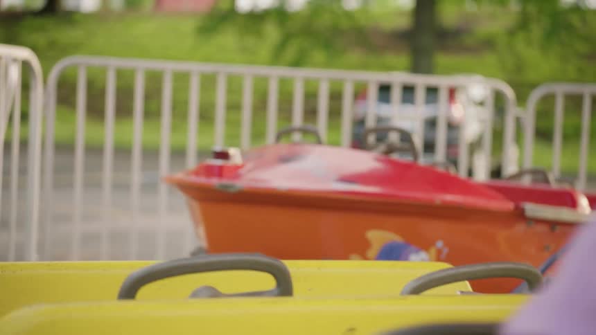 Young children laugh while on a carnival ride