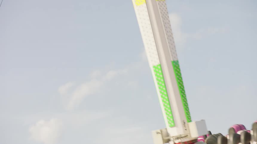 People ride on an attraction at a carnival