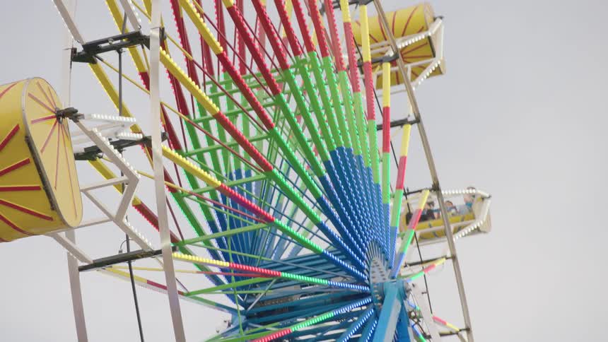 People ride a ferris wheel at a carnival