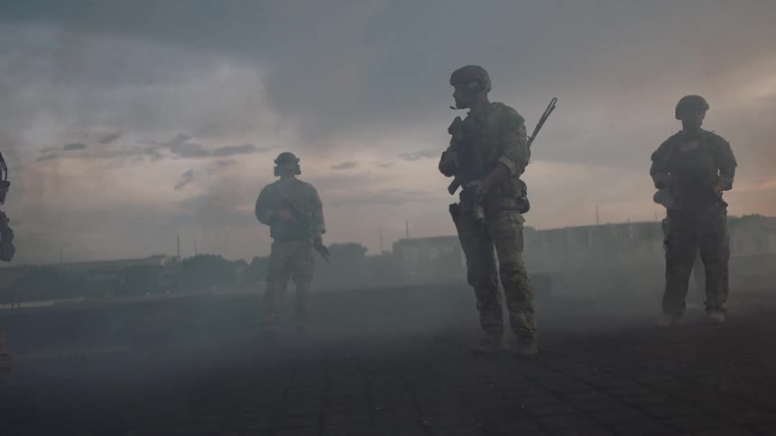 The soldiers line up as smoke rolls past them