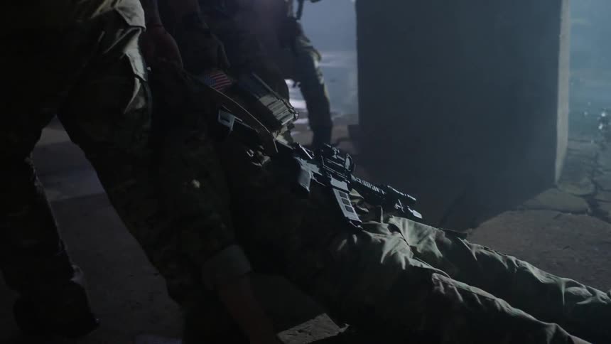 Soldiers drag a fallen comrade
