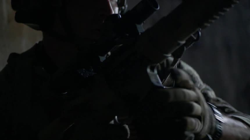 A soldier reloads his gun