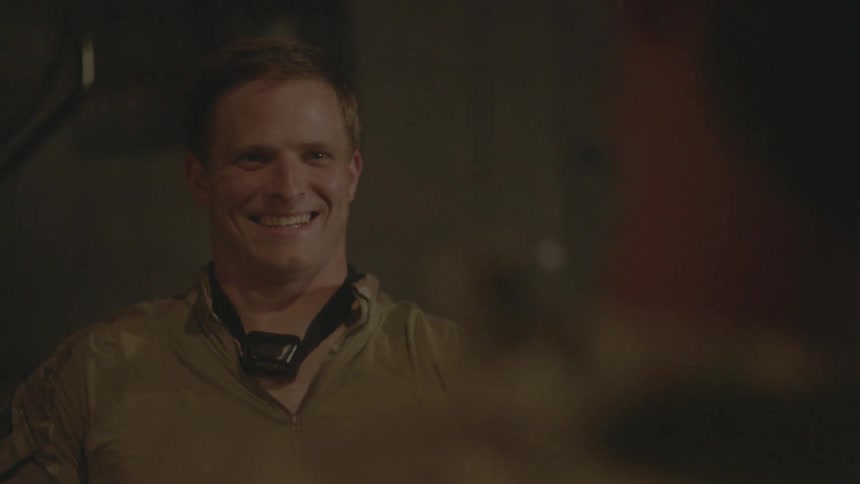 Two soldiers laugh at a table
