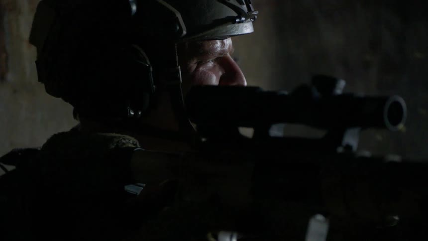 Soldier holds his weapon and shouts commands