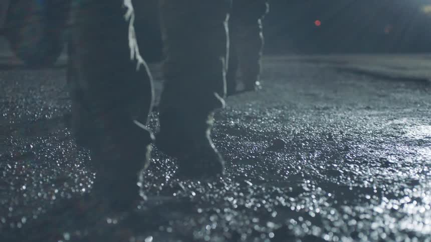 Soldiers walk toward a truck at night