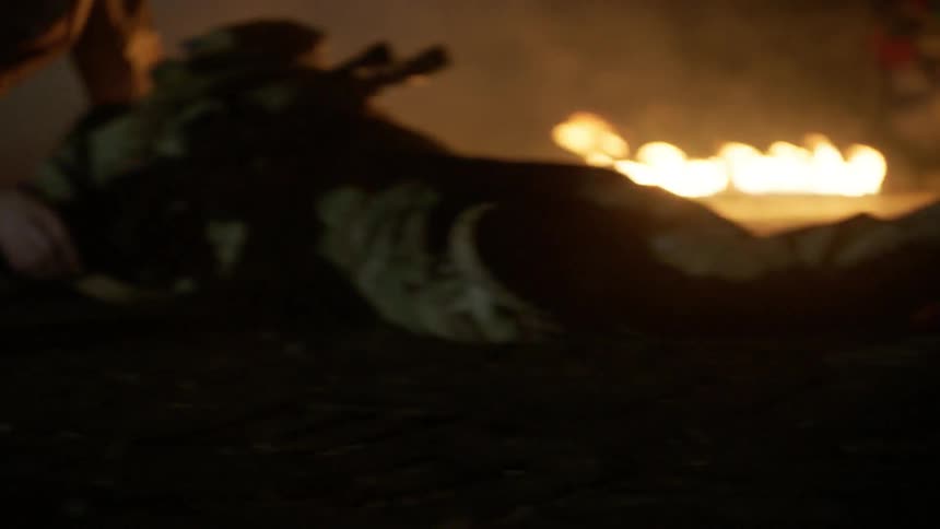 Soldiers running towards a fallen soldier
