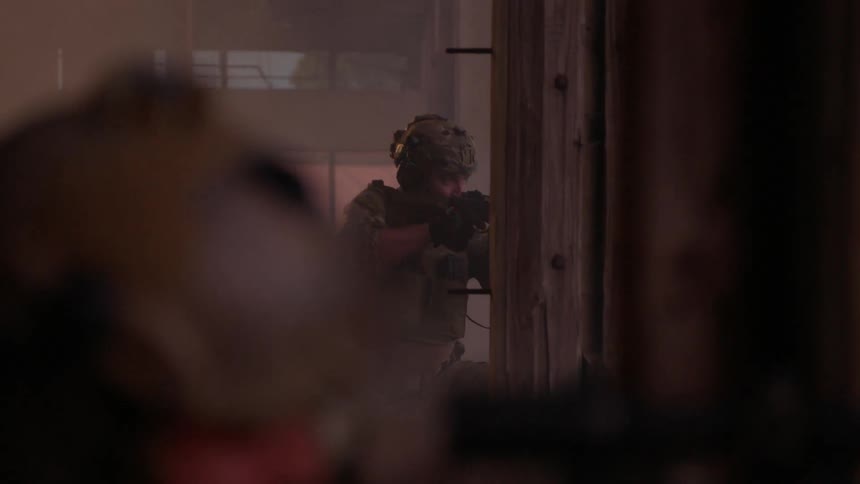 Soldiers aim their weapons and then run