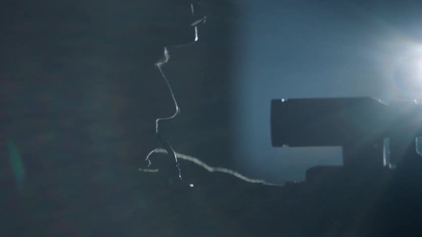 A soldier holds a gun in the dark