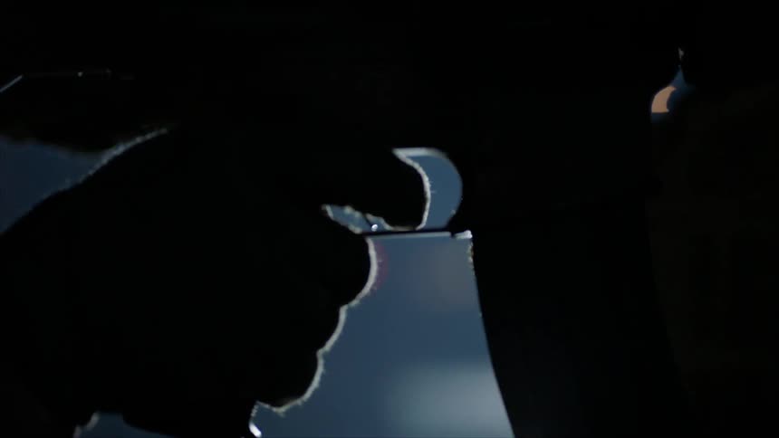 A man holds with his finger on the trigger of a rifle