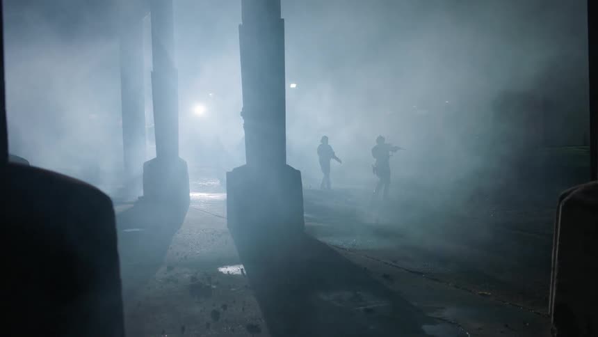 Soldiers walk in the distance in the fog