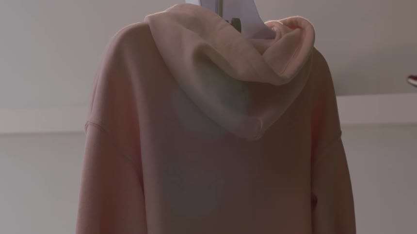 A pink jacket rotates in a clothes shop