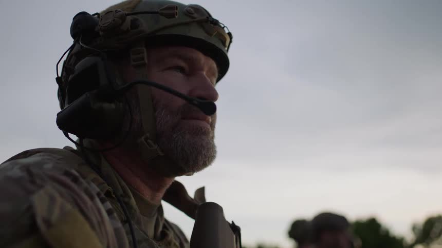 A soldier looks forward on a cloudy day