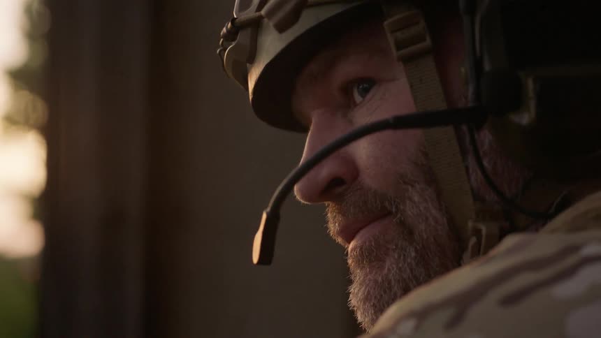 Man wearing a helmet looks outside