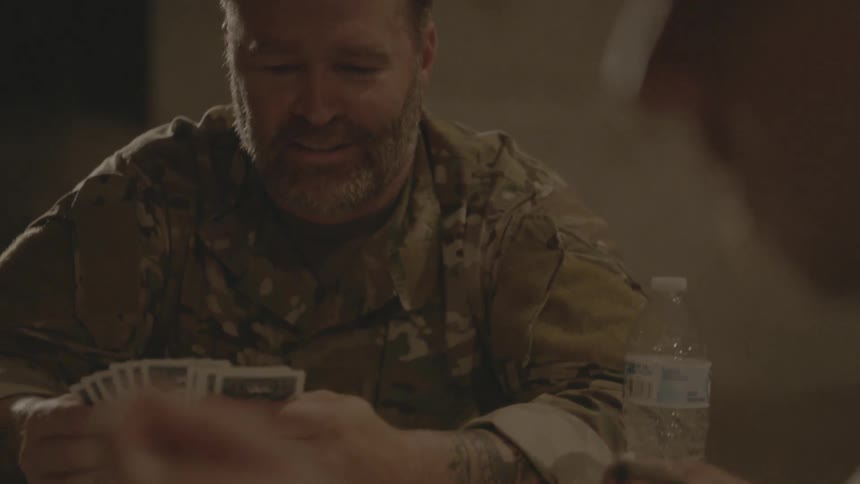 Soldiers relax together and play cards