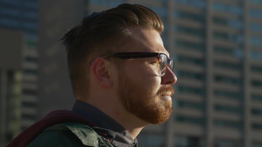 Man looks out over a city on a cloudy day