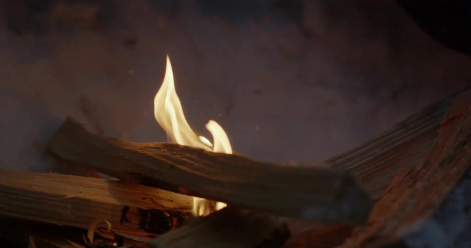Fire is burning on some pieces of wood