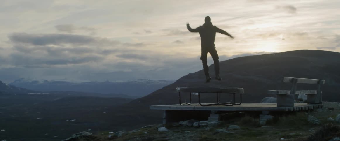 A man is jumping on a trampoline