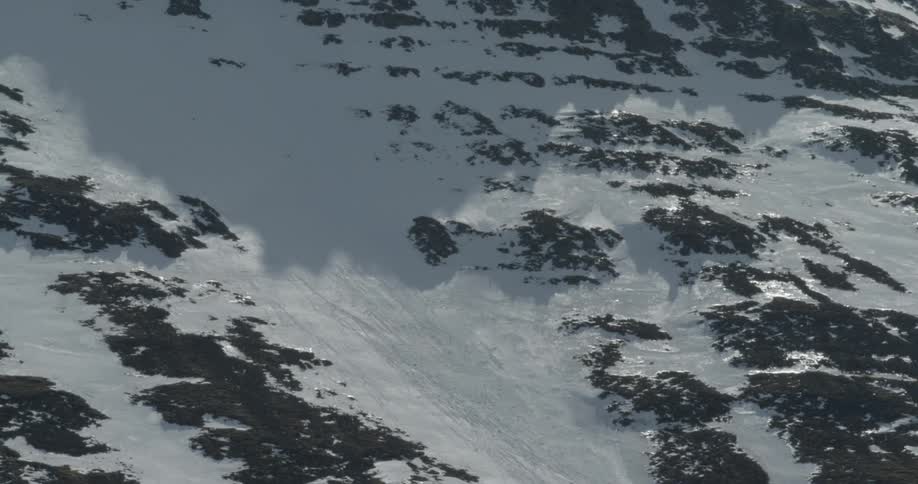 The mountain is covered with snow and ice on a sunny day