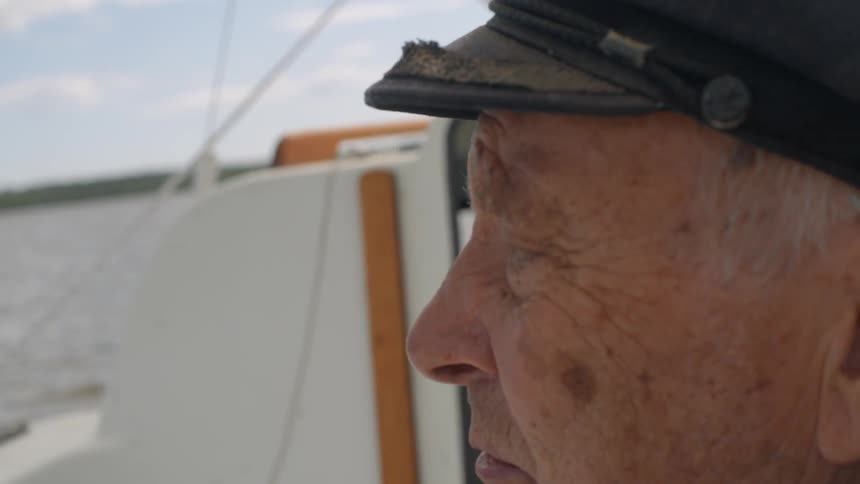 A man on a boat looking out at the water