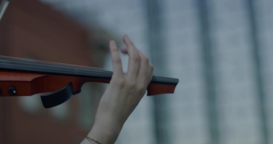 Someone is playing the violin outdoors