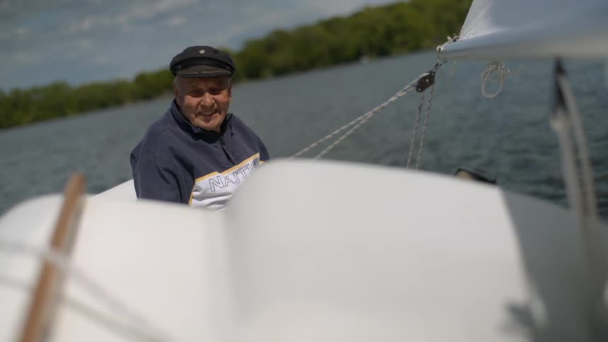 Man smiling as he sits on a boat