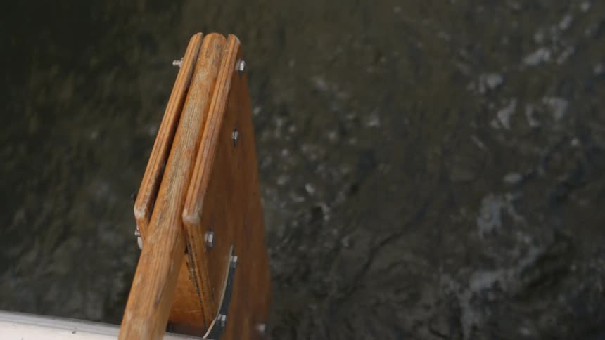 A steering board on the back of a boat