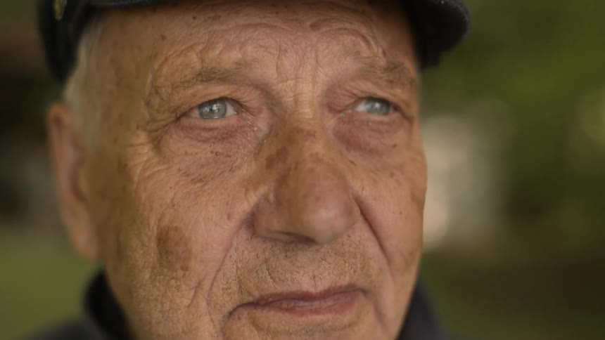 Older man looks around in front of him
