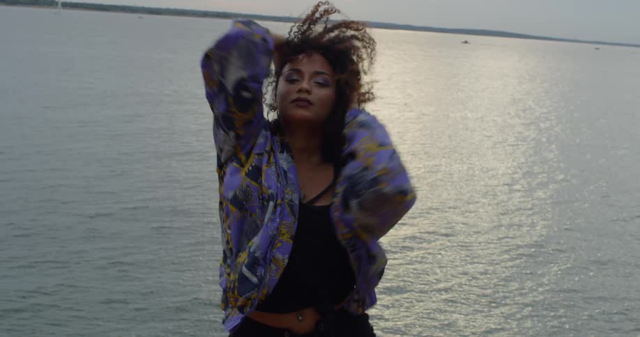 A woman is dancing on a windy day