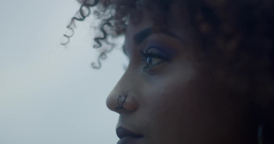 Woman with a nose ring blinks her eyes