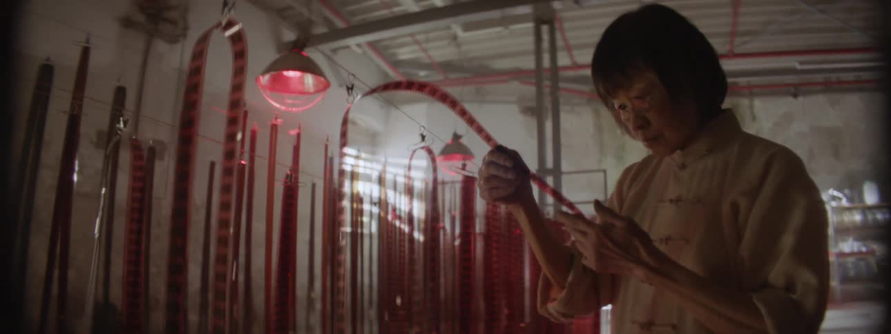 A woman becomes frustrated as she examines strips of film