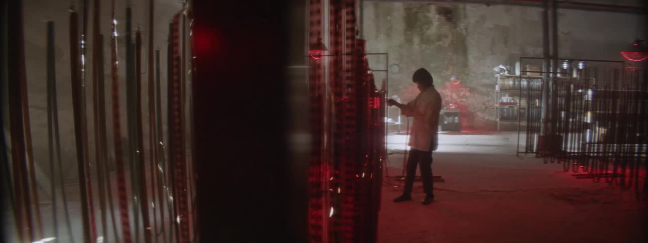 Woman looks at filmstrip hanging in a warehouse