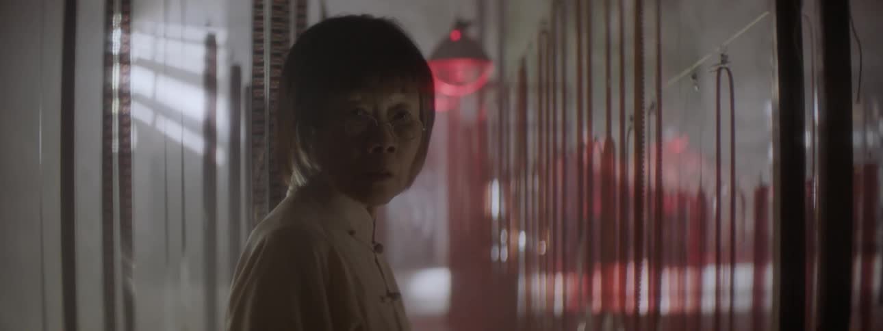 A woman turns around by film hanging