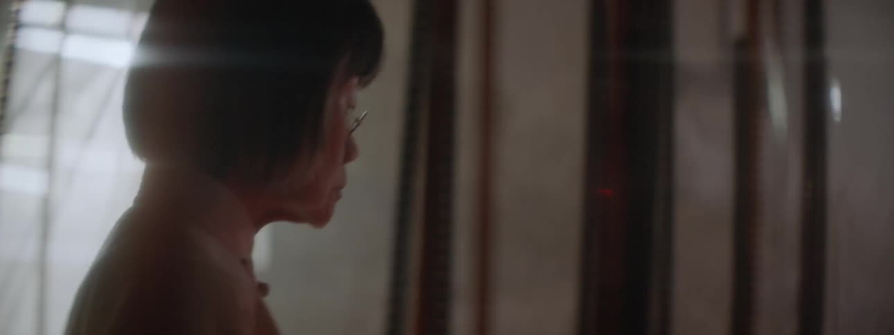 A woman walks past the rolls of film hanging