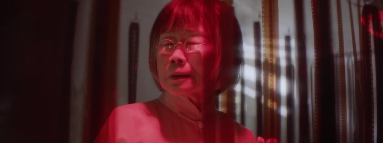 A woman looks at film negatives
