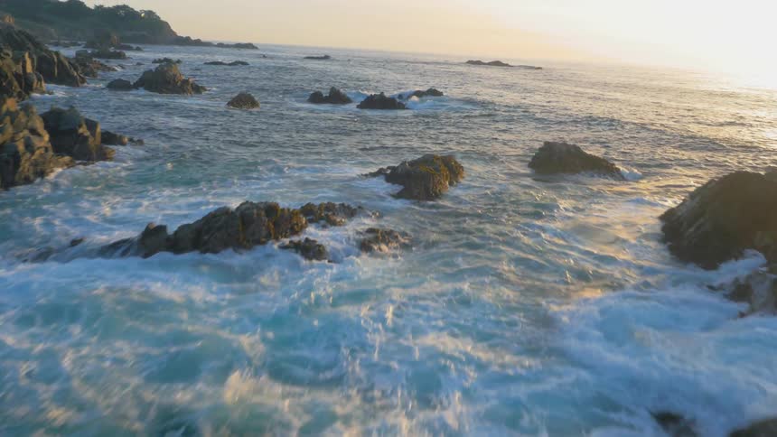 Waves flow towards the rocky shore