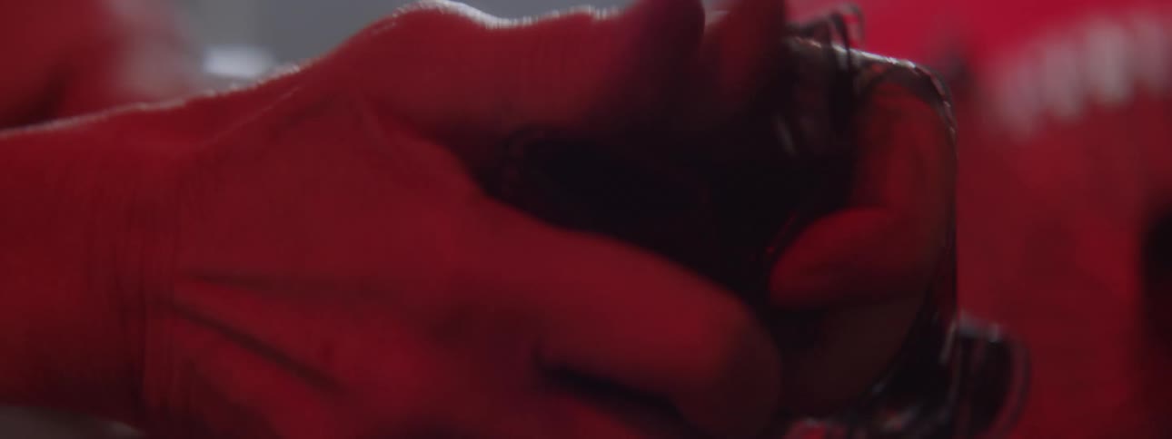 A person crumbles film reels in their hands