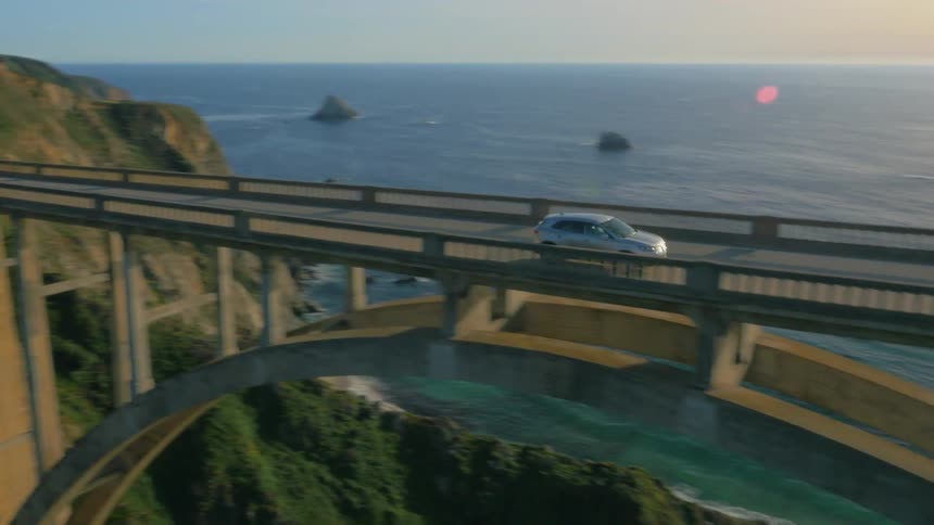 A vehicle drives across the bridge