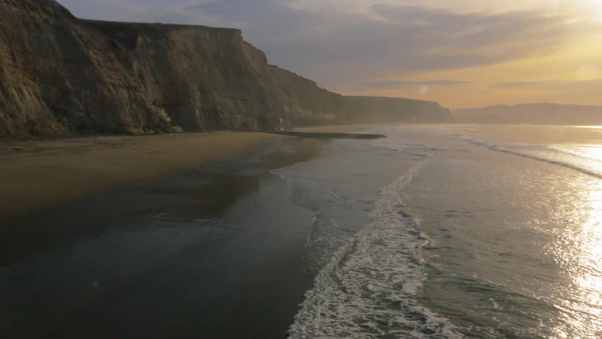 Waves flow onto the beach shore