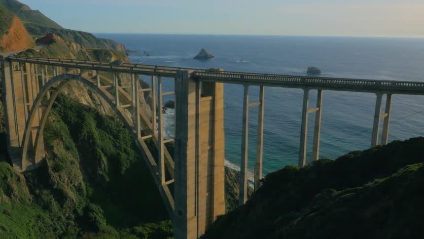 A car travels over a coastal bridge
