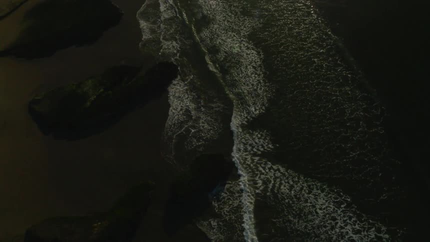 Waves flow onto the beach shore