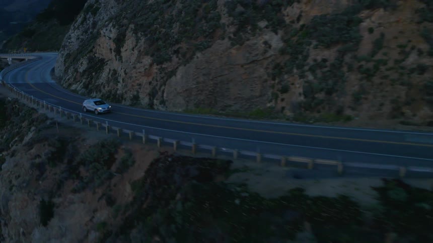 A vehicle travels down a mountain road