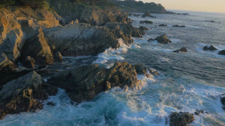Ocean waves splash and break on the rocks