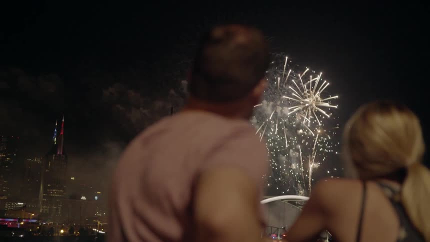 Couple Watching Fireworks Fill The Sky